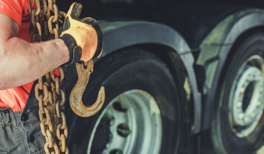 Trucker with Heavy Chains and Hook For Securing Cargo Load. Transportation Industry.